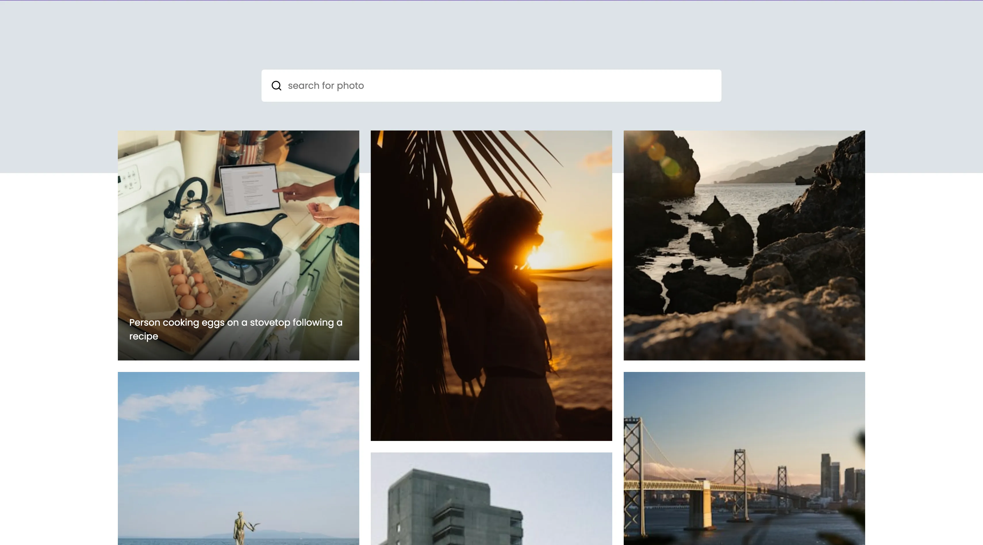 The Gallery app showing a search field above a grid of Unsplash photographs at varying heights.